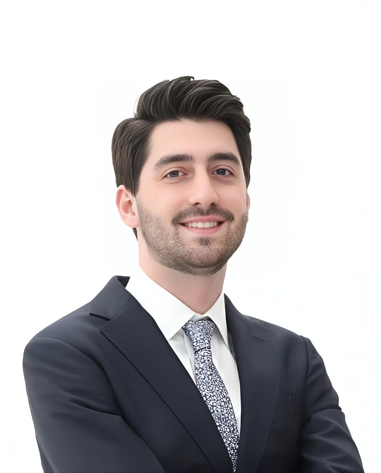 Dr. David Carpinello, orthodontic expert at Carpinello Orthodontics in Drexel Hill, Newtown Square or Edgmont PA, smiles arms crossed in a suit against a white background.