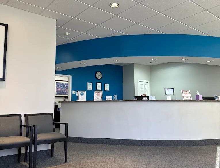 Reception area at Carpinello Orthodontics in Drexel Hill, Newtown Square or Edgmont, PA with blue and white counter and chairs.