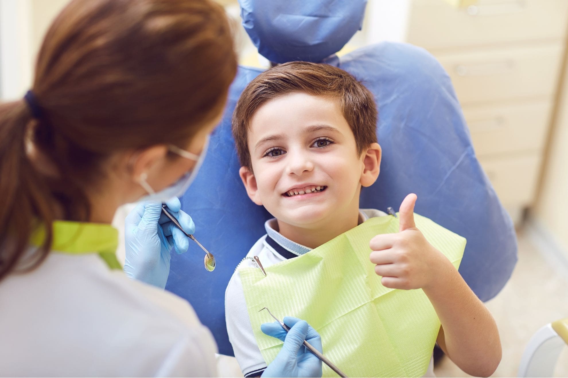 A smiling boy gives a thumbs up in the dental chair for an appointment with the Children's Orthodontist at Carpinello Orthodontics in Drexel Hill, Newtown Square, or Edgmont, PA.