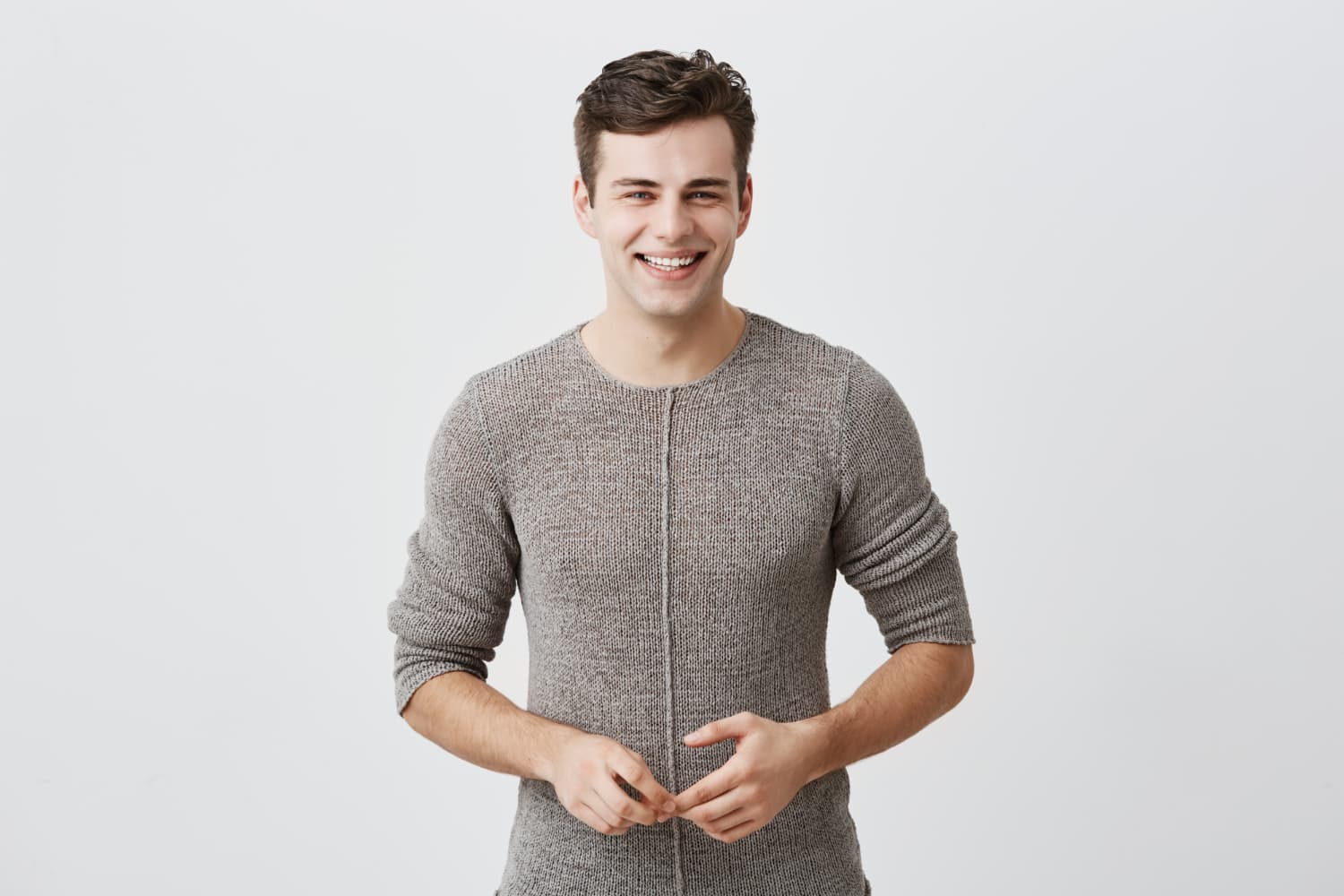 Smiling young man with short brown hair shows clear braces, representing Carpinello Orthodontics in Drexel Hill, Newtown Square or Edgmont, PA.