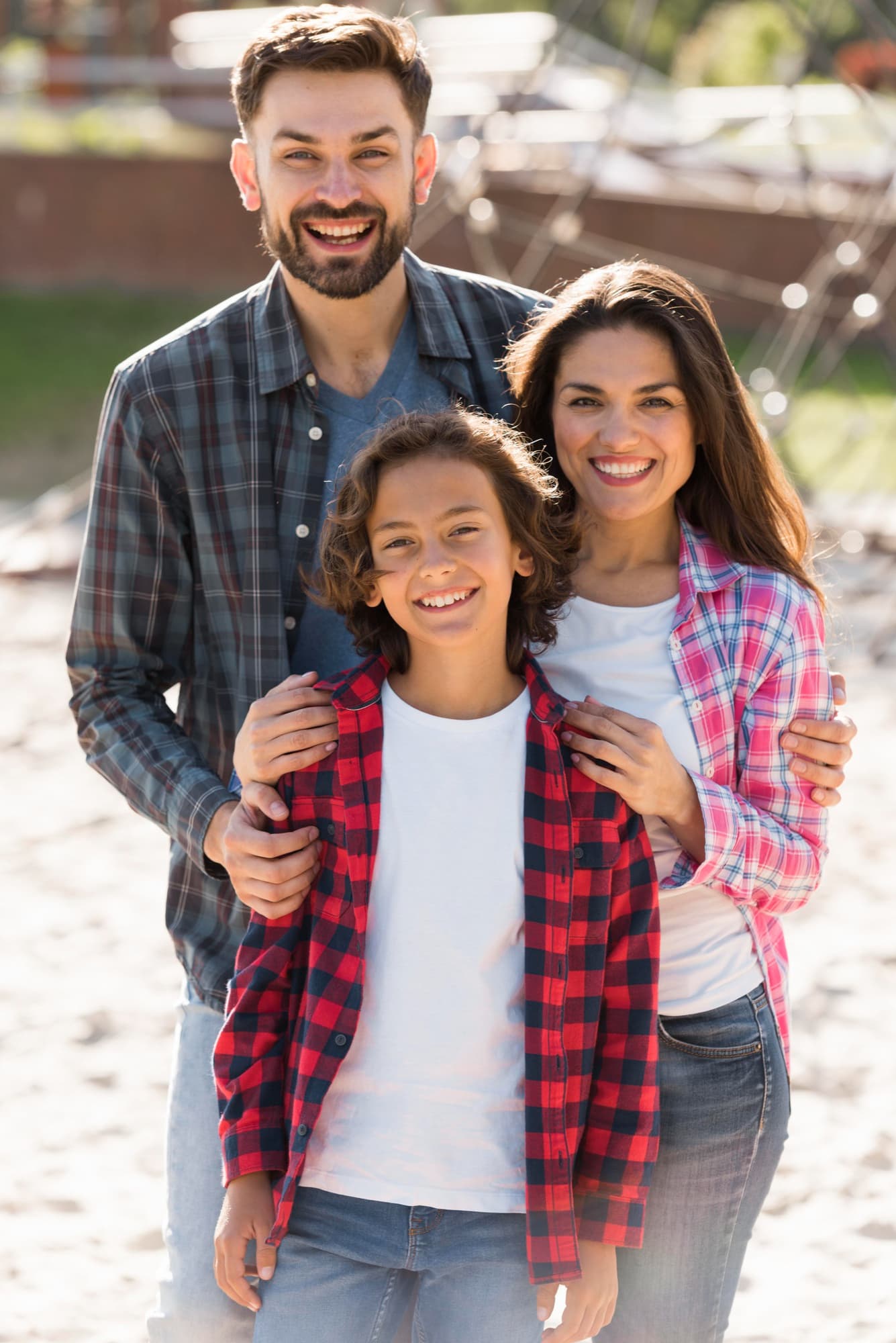 Smiling in matching plaid shirts, a family shows off braces from Carpinello Orthodontics in Drexel Hill, Newtown Square or Edgmont, PA.