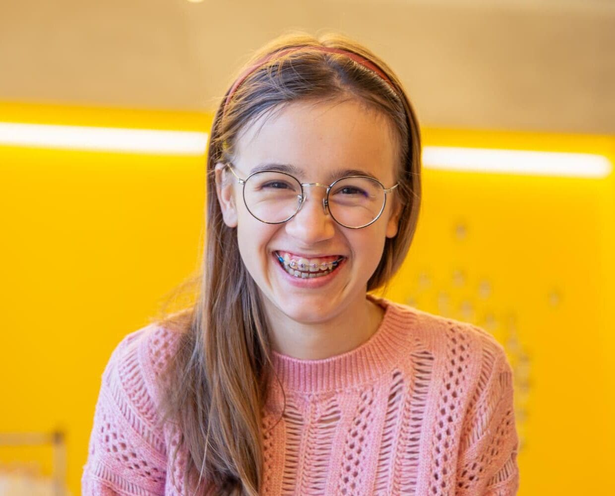 Smiling with traditional braces and glasses, from a children’s orthodontist at Carpinello Orthodontics in Drexel Hill, Newtown Square, or Edgmont, PA.