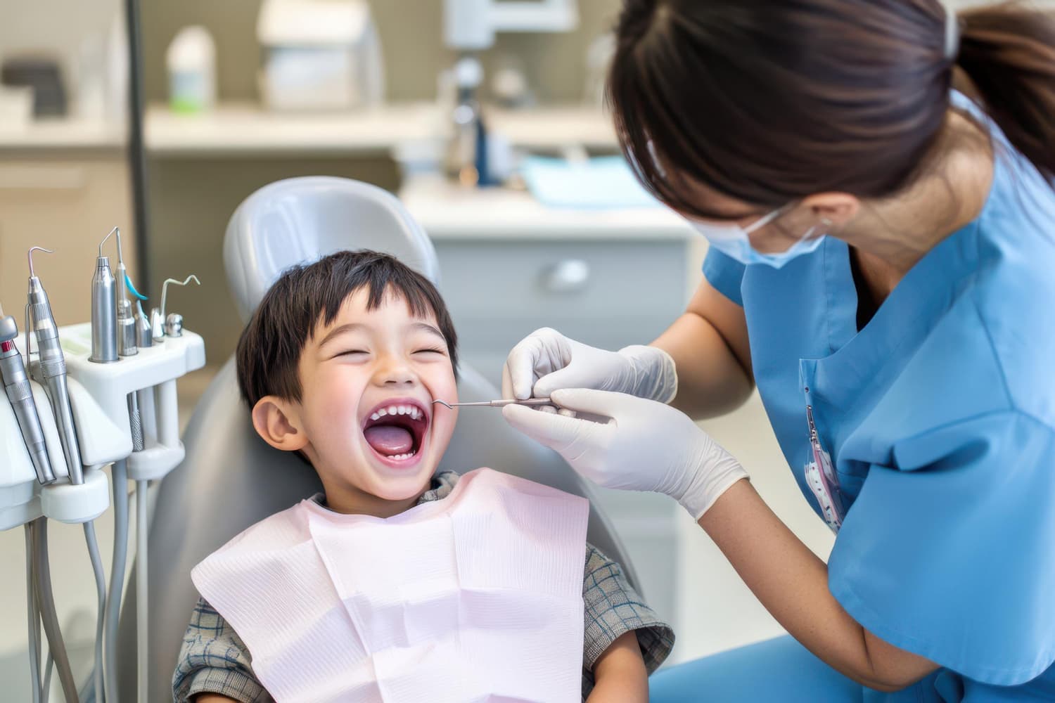 A smiling kids in a dental chair showing the importance of early orthodontic intervention visits to children's orthodontist at Carpinello Orthodontics in Drexel Hill, Newtown Square, or Edgmont, PA.