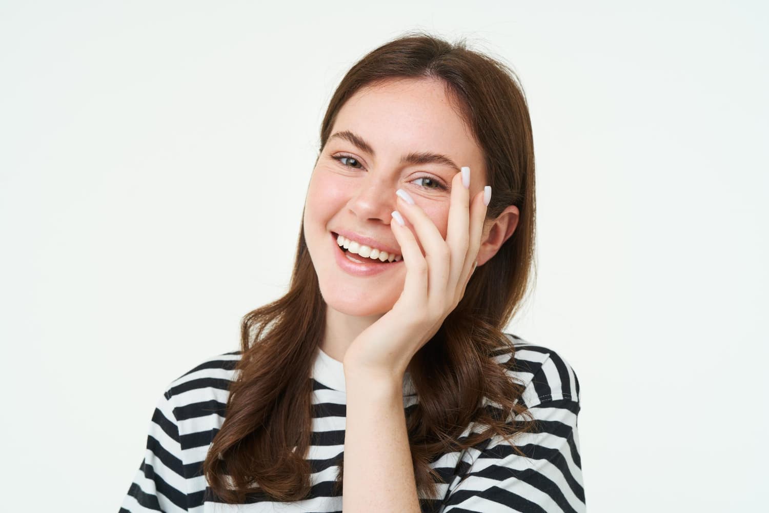 A confident young woman in a striped shirt smiles after her palate expander at Carpinello Orthodontics in Drexel Hill, Newtown Square or Edgmont, PA.