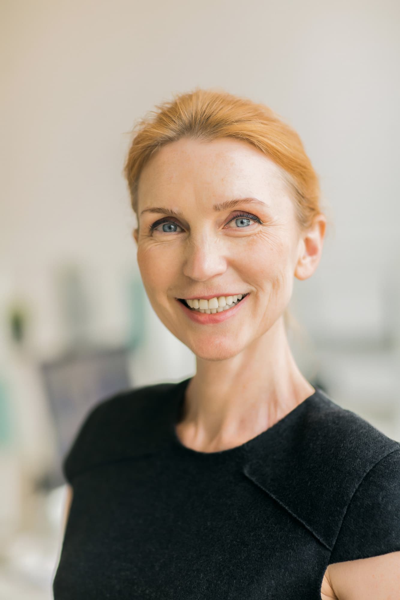 Smiling woman with fair skin and red hair shows off affordable braces from Carpinello Orthodontics in Drexel Hill, Newtown Square or Edgmont, PA.