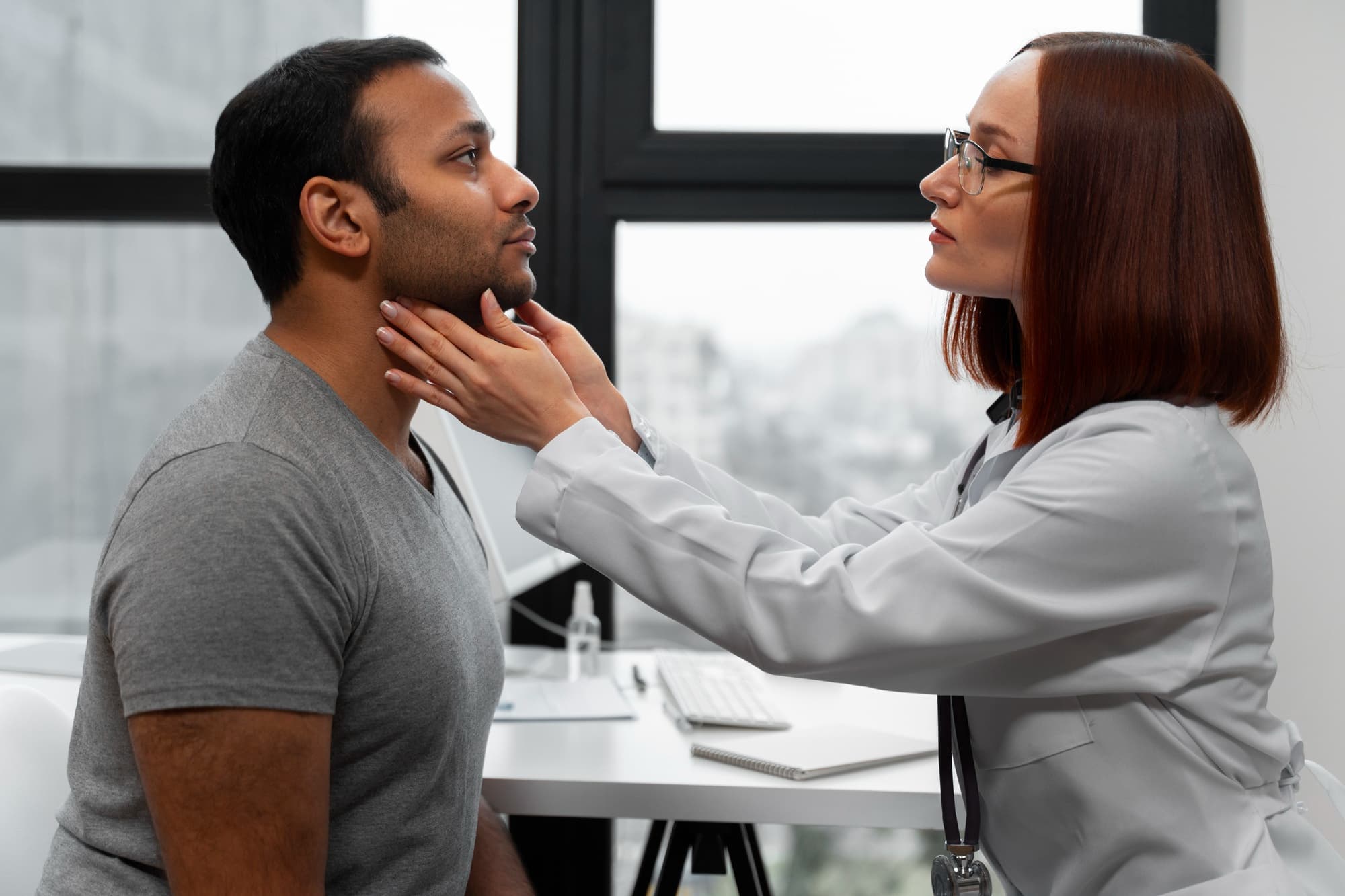 In a Carpinello Orthodontics office in Drexel Hill, Newtown Square or Edgmont, PA, a doctor checks a man's neck for jaw surgery needs.