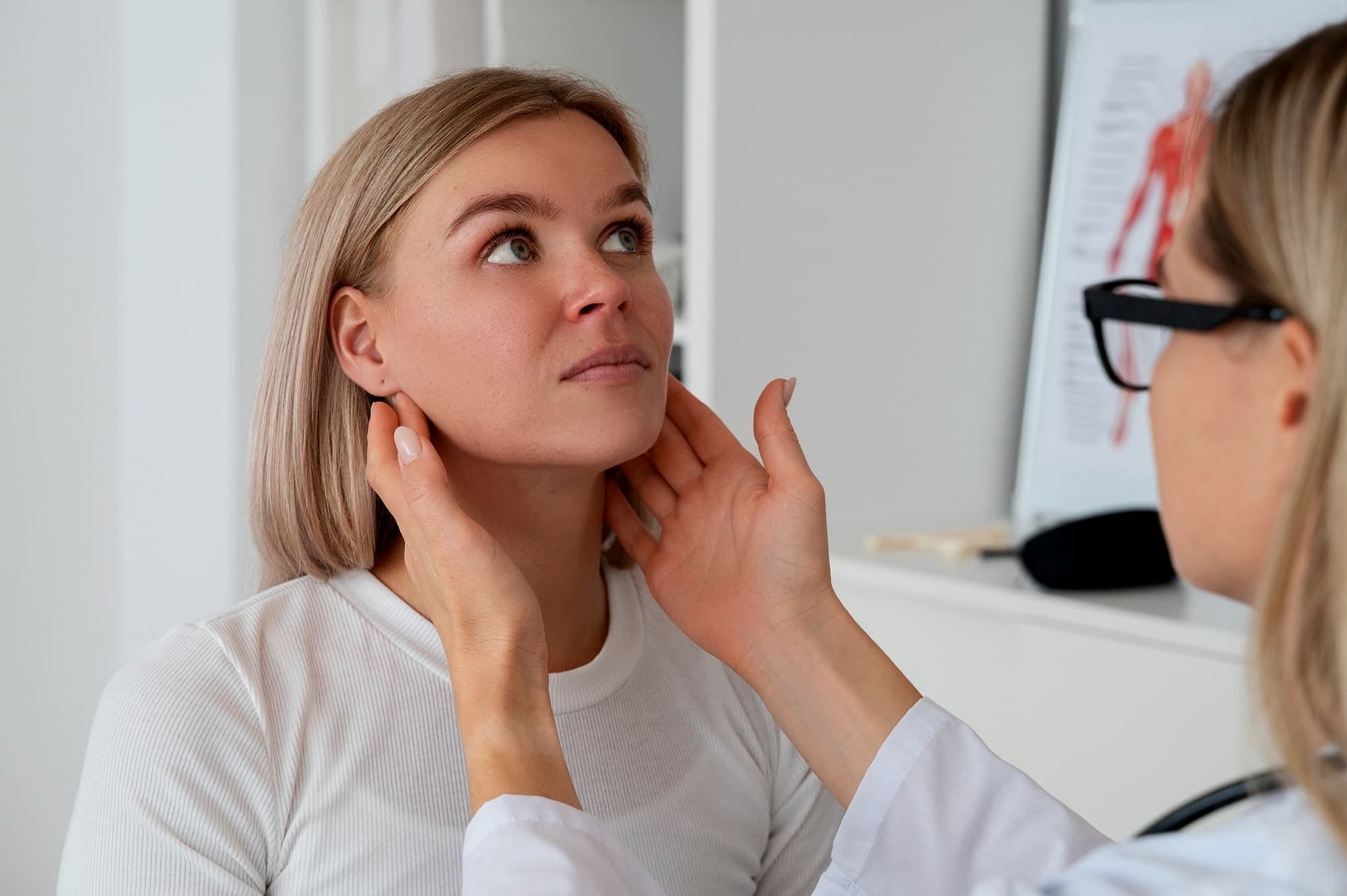 A healthcare professional at Carpinello Orthodontics in Drexel Hill, Newtown Square or Edgmont, PA examines a woman's neck post-jaw surgery.