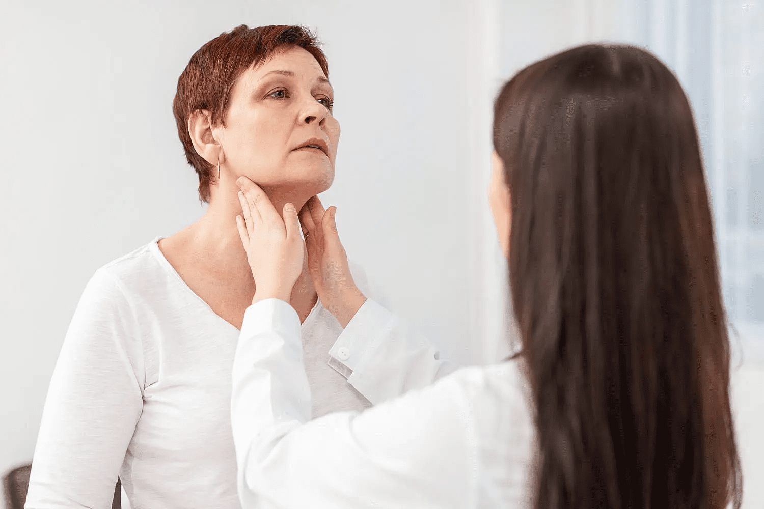At Carpinello Orthodontics in Drexel Hill, Newtown Square or Edgmont, PA, a clinician checks a woman’s neck after jaw surgery.