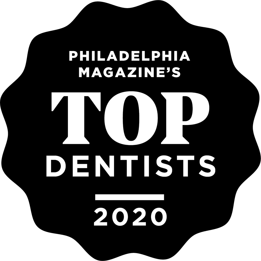 A smiling girl holds and points to an Invisalign Teen aligner with Carpinello Orthodontics in Drexel Hill, Newtown Square or Edgmont, PA, on a blue background. A smiling girl holds and points to an Invisalign Teen aligner with Carpinello Orthodontics in Drexel Hill, Newtown Square or Edgmont, PA, on a blue background.