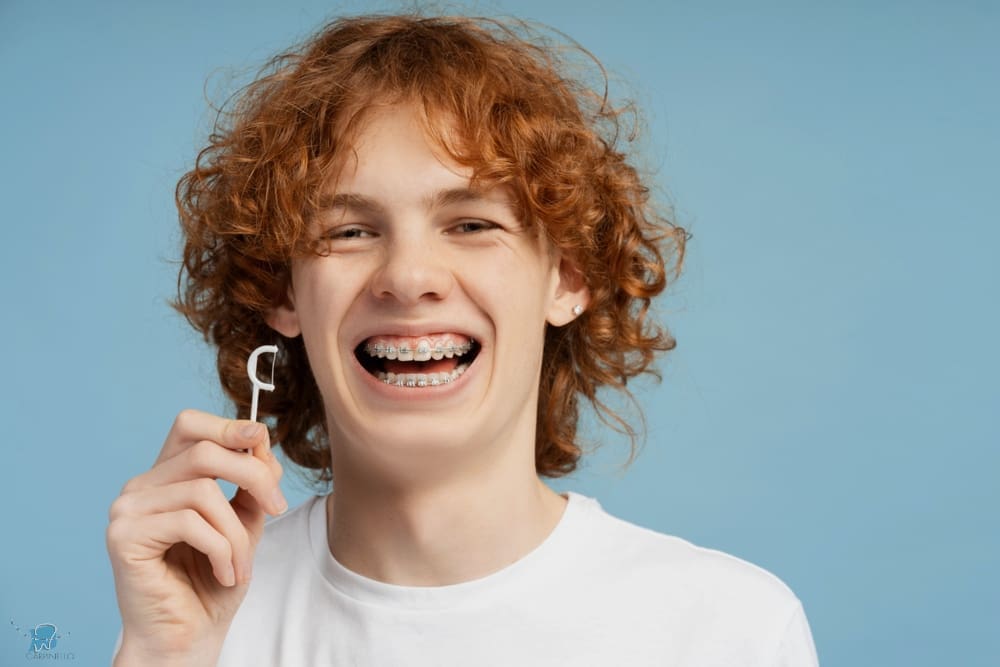 closeup image smiling teenager curly red hair metal braces - How to Floss with Braces in Drexel Hill, Newtown Square, and Edgmont, PA. 
